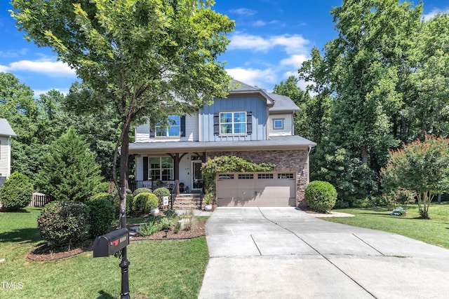 6509 Conaway Ct, Wake Forest, NC 27587 - view of front of home featuring driveway, covered porch, a garage, a front lawn, and board and batten siding