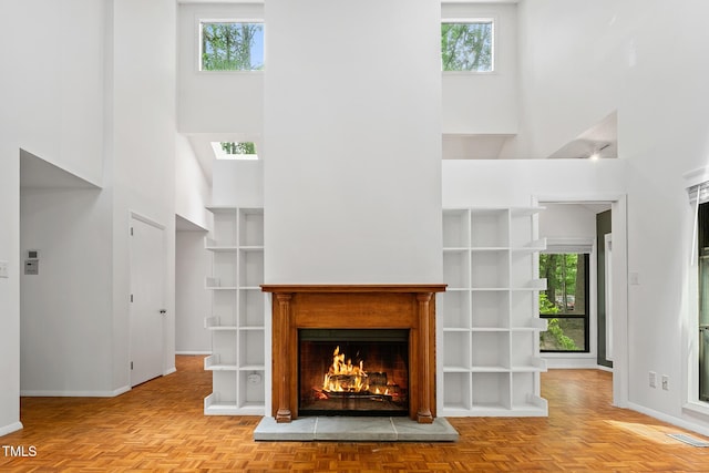 120 Polks Landing Rd, Chapel Hill, NC 27516 - unfurnished living room featuring a high ceiling, plenty of natural light, a lit fireplace, and baseboards