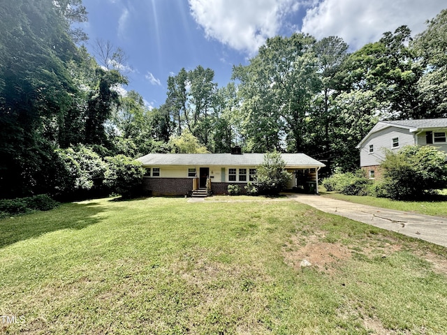 322 S Dixon Ave, Cary, NC 27511 - single story home featuring driveway, a front yard, an attached carport, a chimney, and brick siding