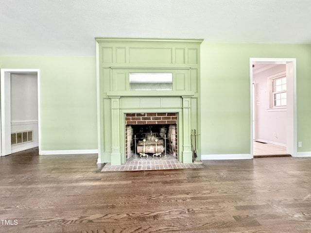 322 S Dixon Ave, Cary, NC 27511 - detailed view of wood finished floors, a fireplace with flush hearth, and baseboards