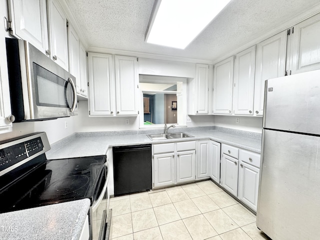 322 S Dixon Ave, Cary, NC 27511 - kitchen with stainless steel appliances, a sink, white cabinetry, light tile patterned flooring, and light countertops