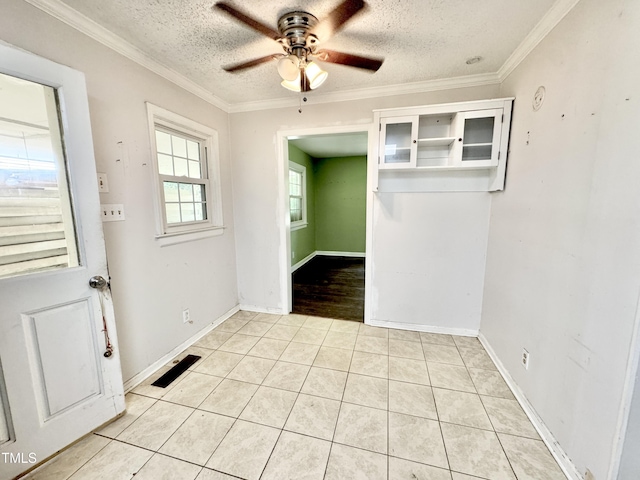 322 S Dixon Ave, Cary, NC 27511 - spare room with a textured ceiling, ceiling fan, light tile patterned floors, ornamental molding, and baseboards
