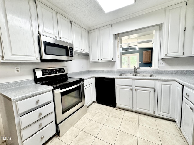 322 S Dixon Ave, Cary, NC 27511 - kitchen with stainless steel appliances, a sink, white cabinets, light countertops, and a textured ceiling