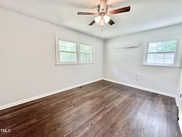 322 S Dixon Ave, Cary, NC 27511 - spare room featuring healthy amount of natural light, dark wood-style flooring, a ceiling fan, and baseboards