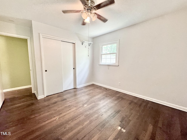 322 S Dixon Ave, Cary, NC 27511 - unfurnished bedroom with baseboards, dark wood finished floors, a closet, and a ceiling fan