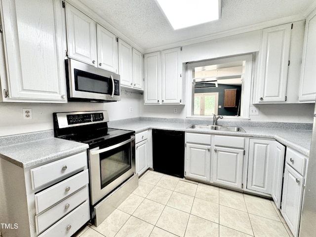 322 S Dixon Ave, Cary, NC 27511 - kitchen with stainless steel appliances, a sink, white cabinets, light tile patterned floors, and light countertops