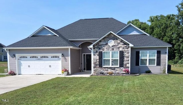 106 Gabor Ln, Goldsboro, NC 27530 - view of front of home with an attached garage, a front lawn, driveway, and stone siding