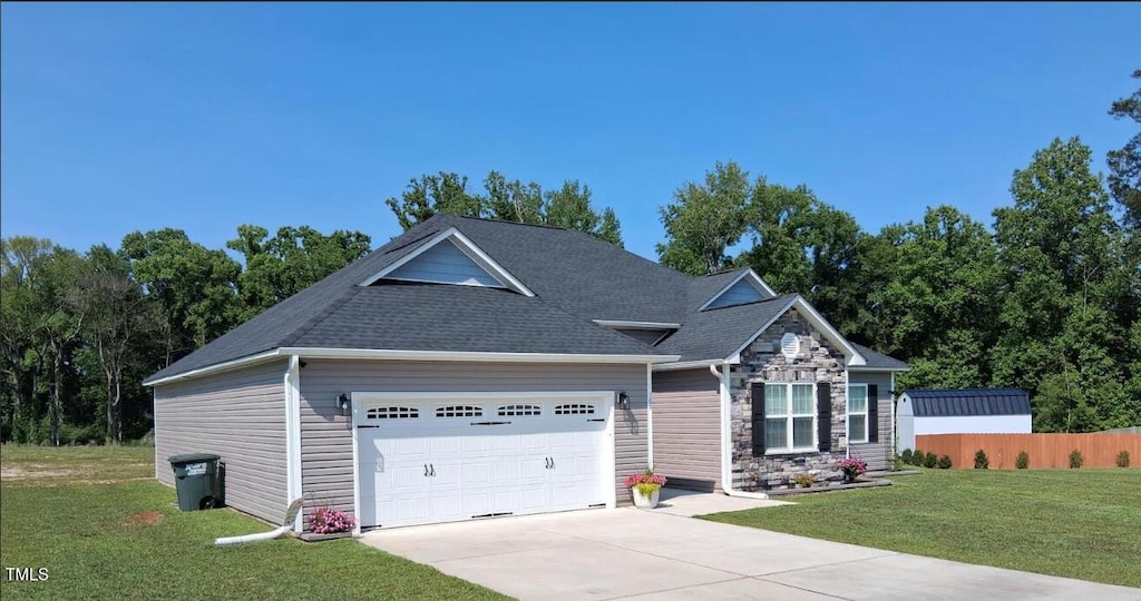 106 Gabor Ln, Goldsboro, NC 27530 - view of front of property with an attached garage, driveway, stone siding, and a shingled roof