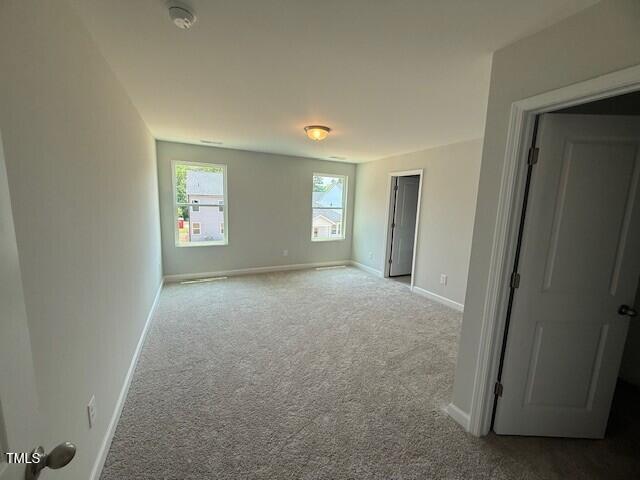 285 Gregory Village Dr, Lillington, NC 27546 - carpeted empty room featuring baseboards and a smoke detector