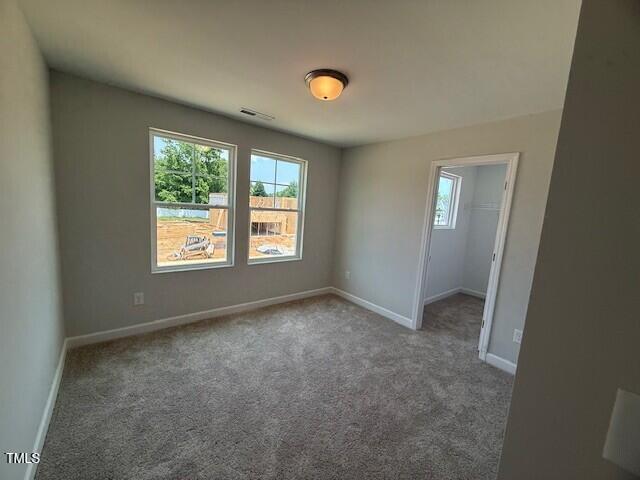 285 Gregory Village Dr, Lillington, NC 27546 - spare room with carpet and baseboards