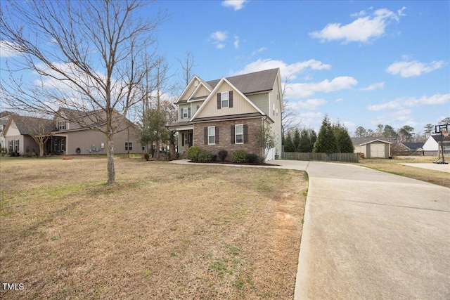 224 Swann Trl, Clayton, NC 27527 - view of front facade featuring concrete driveway, brick siding, and an outbuilding