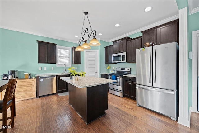 224 Swann Trl, Clayton, NC 27527 - kitchen with stainless steel appliances, dark brown cabinets, crown molding, a center island, and pendant lighting