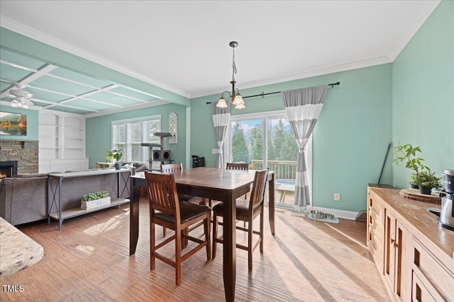 224 Swann Trl, Clayton, NC 27527 - dining space with plenty of natural light, light wood finished floors, baseboards, a chandelier, and crown molding