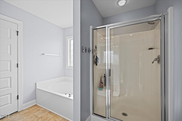 224 Swann Trl, Clayton, NC 27527 - full bath featuring a stall shower, a garden tub, and baseboards