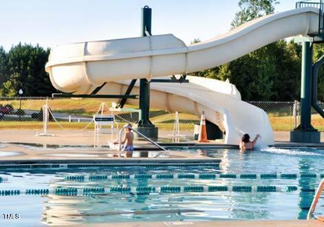 224 Swann Trl, Clayton, NC 27527 - community pool featuring a water slide