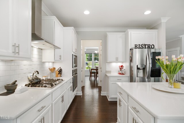 8909 Tara Hill Ln, Wake Forest, NC 27587 - kitchen featuring stainless steel appliances, wall chimney range hood, crown molding, white cabinetry, and backsplash