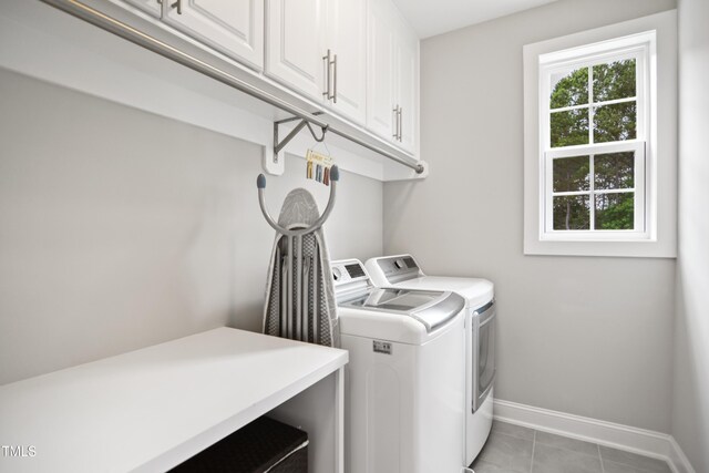 8909 Tara Hill Ln, Wake Forest, NC 27587 - washroom featuring cabinet space, washing machine and clothes dryer, baseboards, and light tile patterned flooring