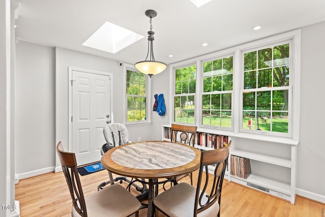 3806 Lochnora Pkwy, Durham, NC 27705 - dining room with a skylight, light wood-type flooring, baseboards, and recessed lighting