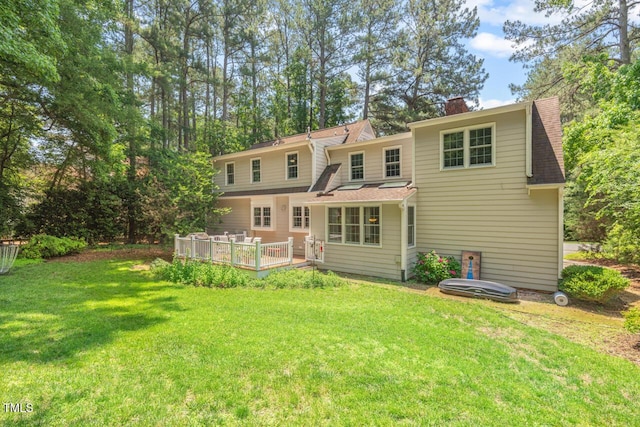 3806 Lochnora Pkwy, Durham, NC 27705 - back of house with a lawn, a deck, a chimney, and a shingled roof