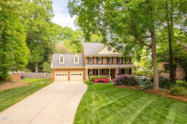 102 Pin Oak Ct, Elon, NC 27244 - colonial inspired home with a porch, driveway, brick siding, and an attached garage