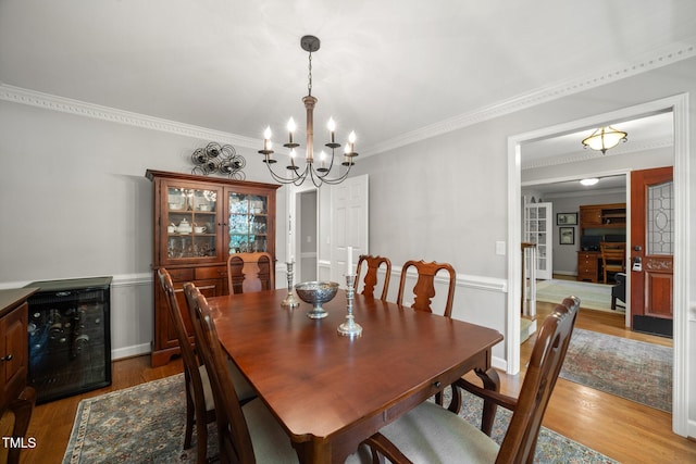102 Pin Oak Ct, Elon, NC 27244 - dining space with ornamental molding, a chandelier, wood finished floors, and wine cooler