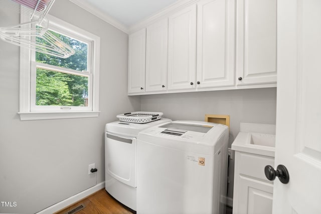 102 Pin Oak Ct, Elon, NC 27244 - laundry room featuring cabinet space, washing machine and dryer, wood finished floors, ornamental molding, and baseboards