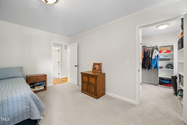 102 Pin Oak Ct, Elon, NC 27244 - carpeted bedroom with crown molding, a walk in closet, baseboards, and a closet