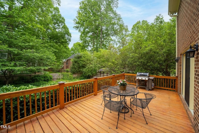102 Pin Oak Ct, Elon, NC 27244 - wooden terrace with outdoor dining area, grilling area, and view of scattered trees