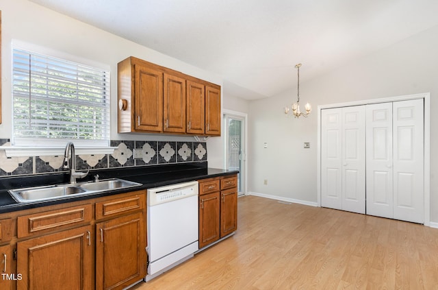 2108 Carthage Cir, Raleigh, NC 27604 - kitchen featuring dishwasher, a sink, brown cabinets, dark countertops, and a chandelier