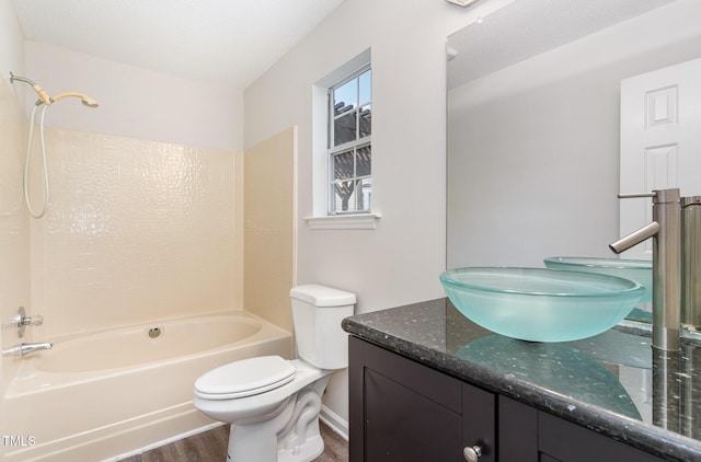 2108 Carthage Cir, Raleigh, NC 27604 - bathroom featuring wood finished floors, vanity, shower / washtub combination, and toilet