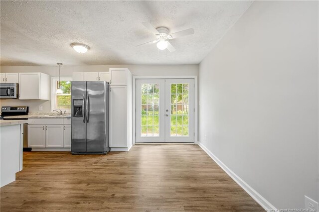 6313 Belle Terre Ct, Fayetteville, NC 28304 - kitchen featuring appliances with stainless steel finishes, a textured ceiling, a ceiling fan, light countertops, and french doors
