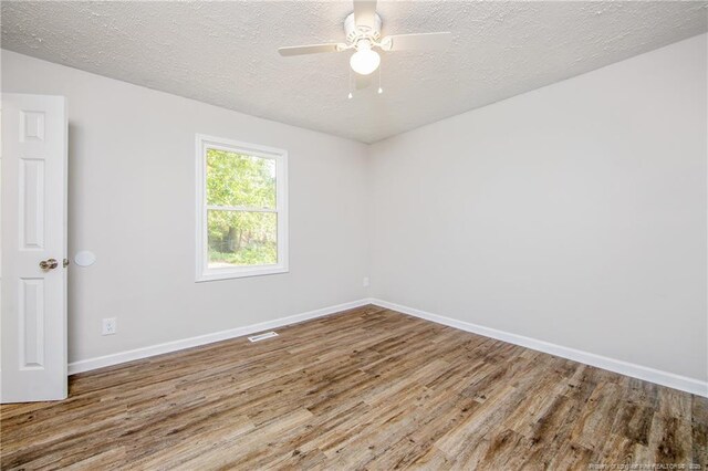 6313 Belle Terre Ct, Fayetteville, NC 28304 - unfurnished room featuring wood finished floors, baseboards, a textured ceiling, and a ceiling fan