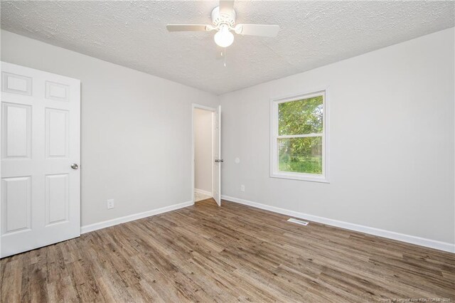 6313 Belle Terre Ct, Fayetteville, NC 28304 - unfurnished room with wood finished floors, baseboards, a textured ceiling, and ceiling fan