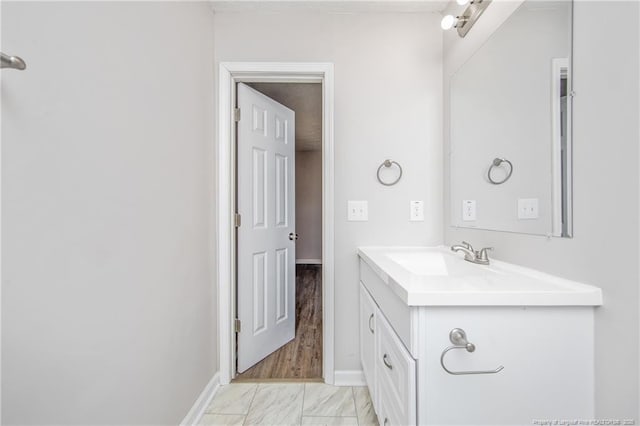 6313 Belle Terre Ct, Fayetteville, NC 28304 - bathroom with vanity, marble look tiles, and baseboards