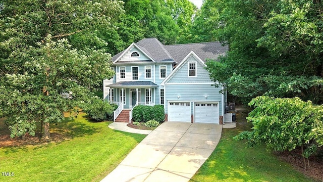 1128 Neuse Ridge Dr, Clayton, NC 27527 - view of front of house featuring concrete driveway, a porch, a front yard, central air condition unit, and an attached garage