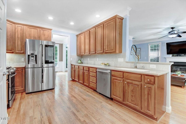 1128 Neuse Ridge Dr, Clayton, NC 27527 - kitchen with stainless steel appliances, a sink, tasteful backsplash, light wood-type flooring, and ornamental molding