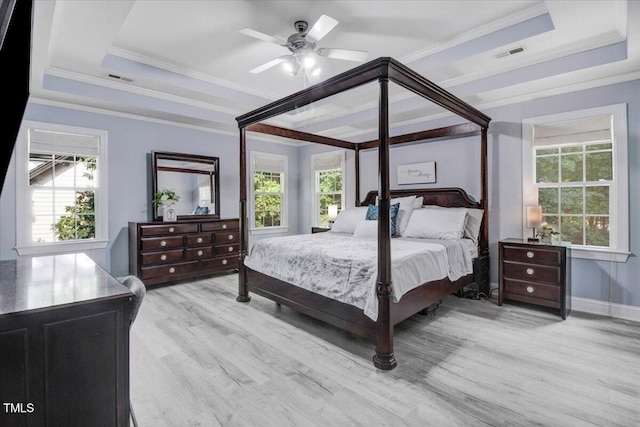 1128 Neuse Ridge Dr, Clayton, NC 27527 - bedroom with a tray ceiling, multiple windows, crown molding, and wood finished floors