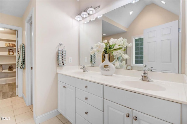 1128 Neuse Ridge Dr, Clayton, NC 27527 - full bath featuring double vanity, tile patterned flooring, vaulted ceiling, recessed lighting, and baseboards