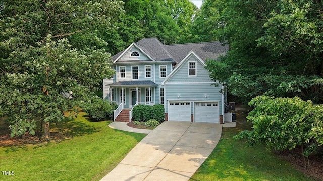 1128 Neuse Ridge Dr, Clayton, NC 27527 - view of front facade with driveway, a porch, a front yard, central AC unit, and a shingled roof
