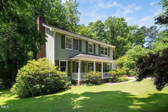 1006 Apache Ln, Apex, NC 27502 - view of front of property with covered porch, a chimney, and a front lawn