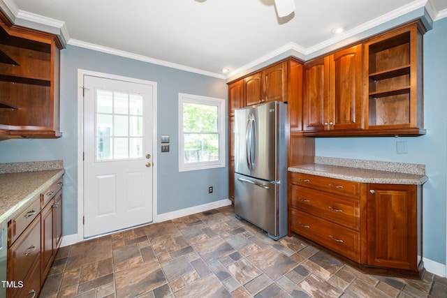1006 Apache Ln, Apex, NC 27502 - kitchen with freestanding refrigerator, open shelves, baseboards, crown molding, and stone finish flooring