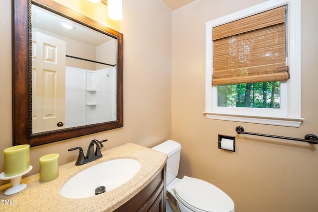 1006 Apache Ln, Apex, NC 27502 - bathroom featuring toilet, vanity, and a shower