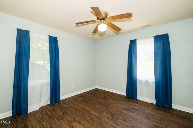1006 Apache Ln, Apex, NC 27502 - empty room with healthy amount of natural light, wood finished floors, and baseboards