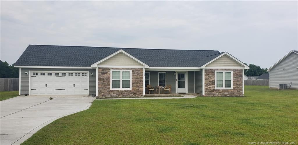 138 Canady Rd, Parkton, NC 28371 - craftsman-style home featuring stone siding, central AC, a porch, driveway, and an attached garage