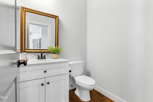 118 Fox Run Ct, Durham, NC 27705 - half bath featuring wood finished floors, toilet, vanity, and baseboards