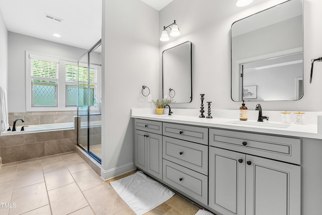 118 Fox Run Ct, Durham, NC 27705 - bathroom with double vanity, a bath, a shower stall, and tile patterned flooring