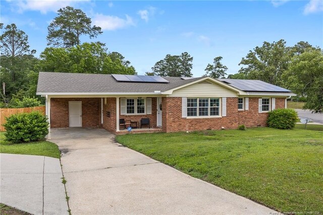 701 Dandridge Dr, Fayetteville, NC 28304 - ranch-style house with driveway, a porch, brick siding, solar panels, and an attached carport