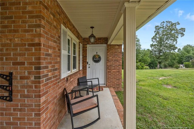 701 Dandridge Dr, Fayetteville, NC 28304 - entrance to property featuring a lawn, brick siding, and covered porch