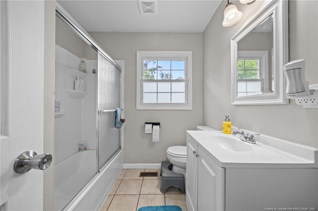 701 Dandridge Dr, Fayetteville, NC 28304 - bathroom featuring toilet, vanity, tile patterned flooring, shower / bath combination with glass door, and baseboards