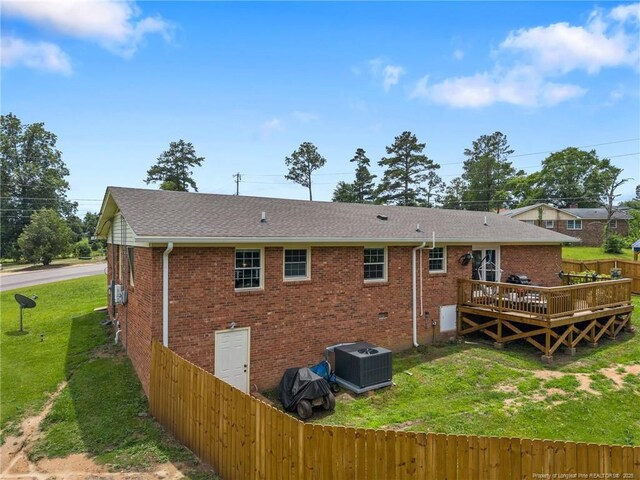 701 Dandridge Dr, Fayetteville, NC 28304 - back of property with roof with shingles, a wooden deck, central AC, and brick siding